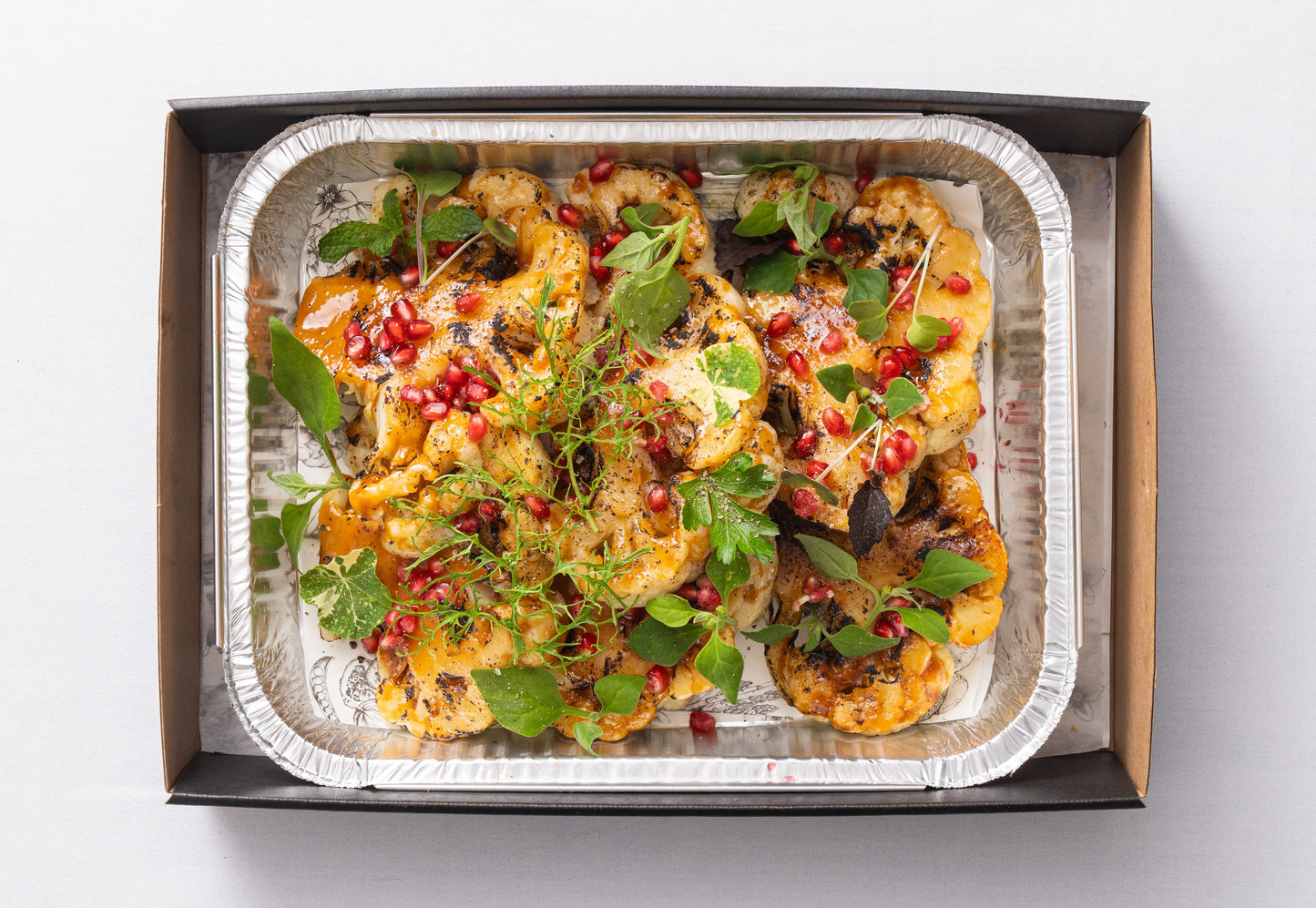 Miso roasted cauliflower steak, pomegranate & fresh herbs